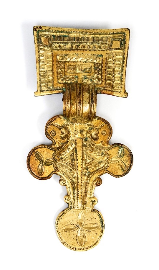 An Anglo-Saxon gilt square headed brooch with motifs and decoration.