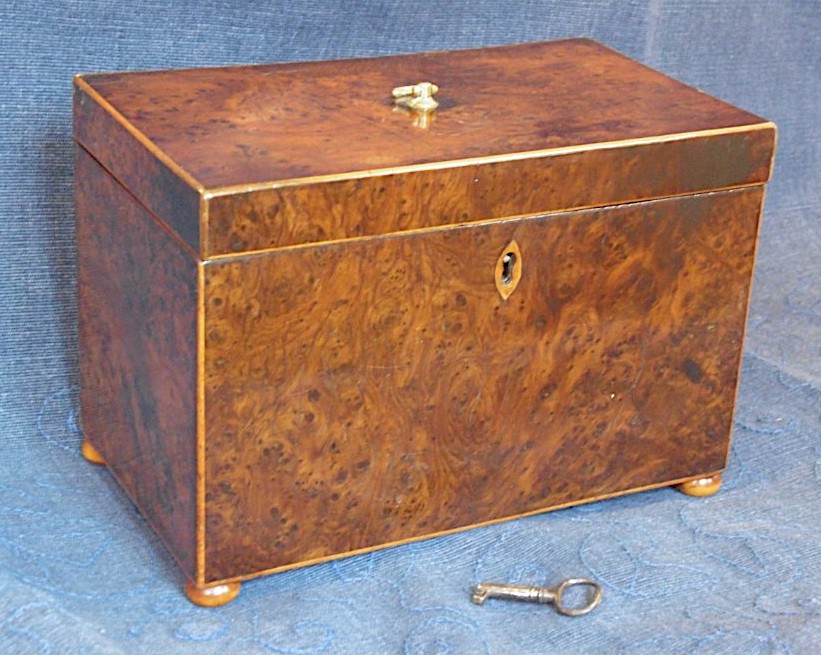 An antique A burr yew tea caddy