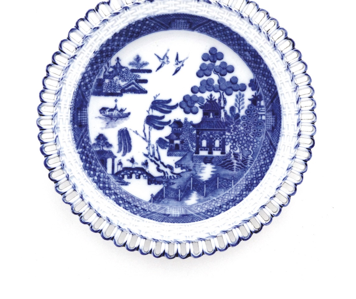 A blue and white willow pattern plate