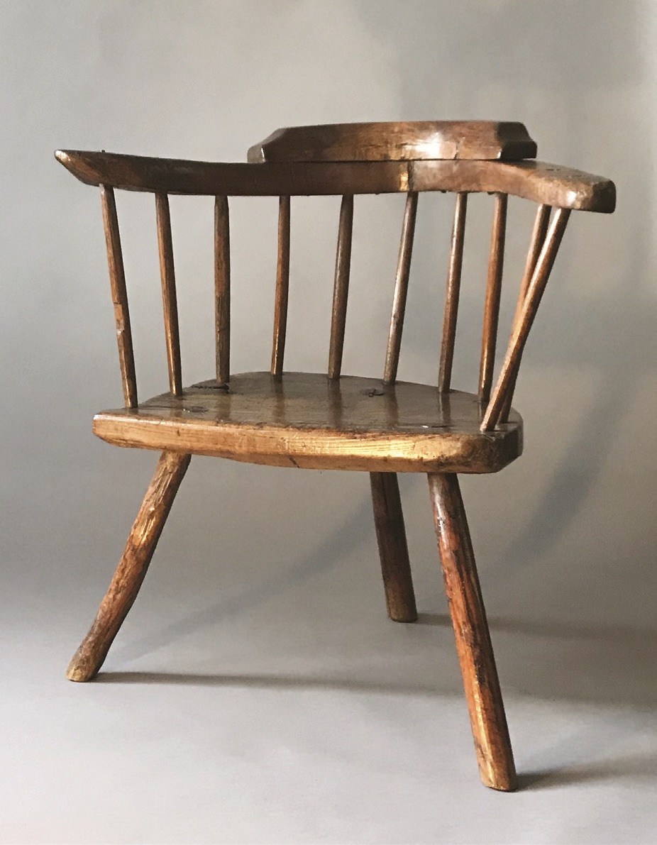 A small lowback 18th-century Cardiganshire stick chair with a wonderful, naturally-shaped one-piece arm with a low crest