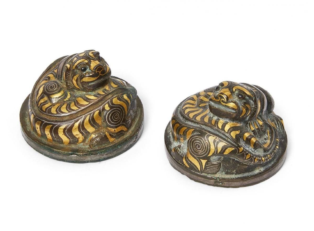 Pair of Chinese bronze and inlaid 'tiger' mat weights, Western Han dynasty