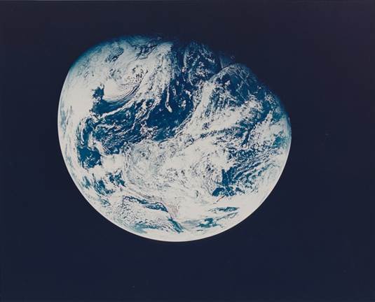 First photograph of the Earth taken by a human from beyond the Earth's orbit