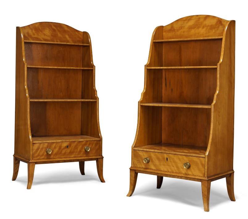 A pair of Regency satinwood waterfall bookcases