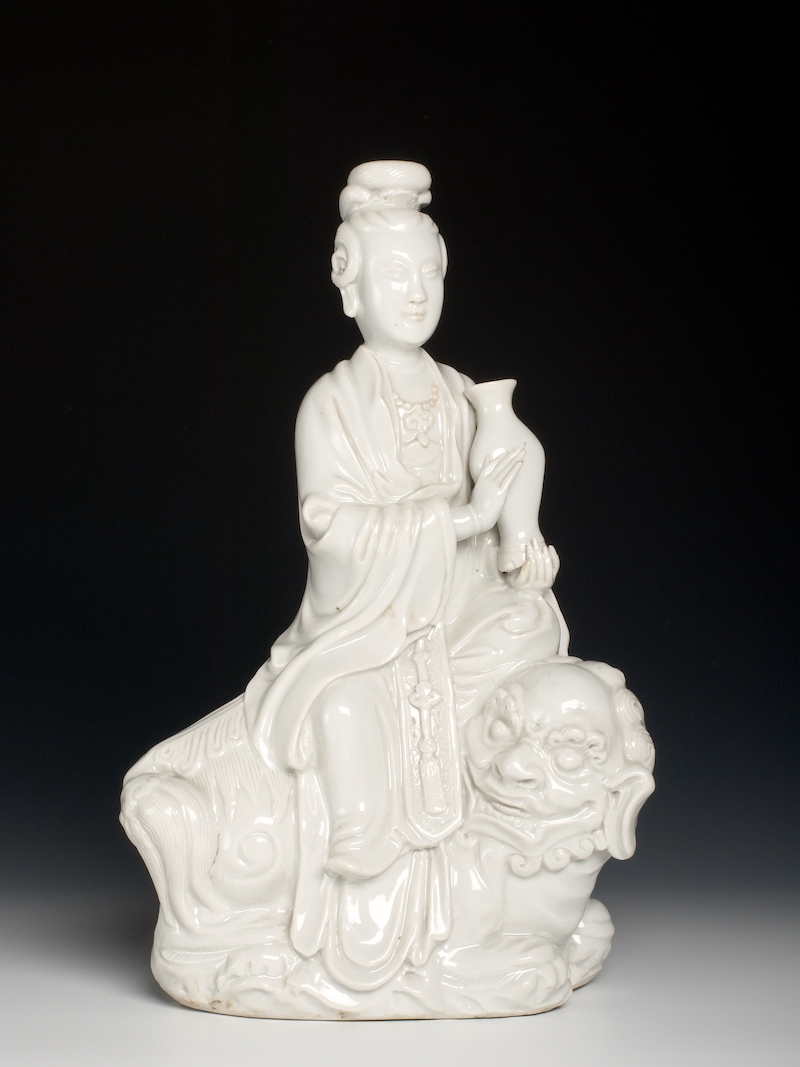 19thC Chinese export Dehua porcelain blanc-de-Chine figure of a maiden seated on a Buddhist lion