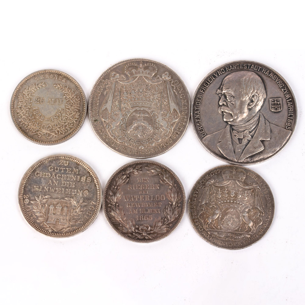 a collection of German coins and medallions