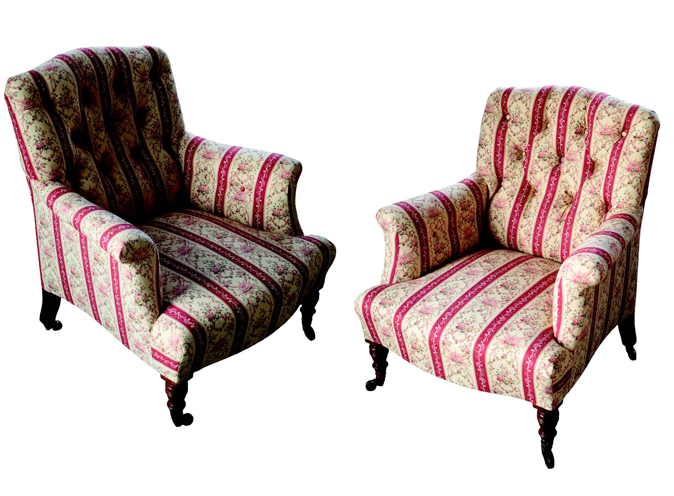 A pair of Victorian upholstered armchairs by Howard & Sons, later reupholstered in red, white and foliate cotton