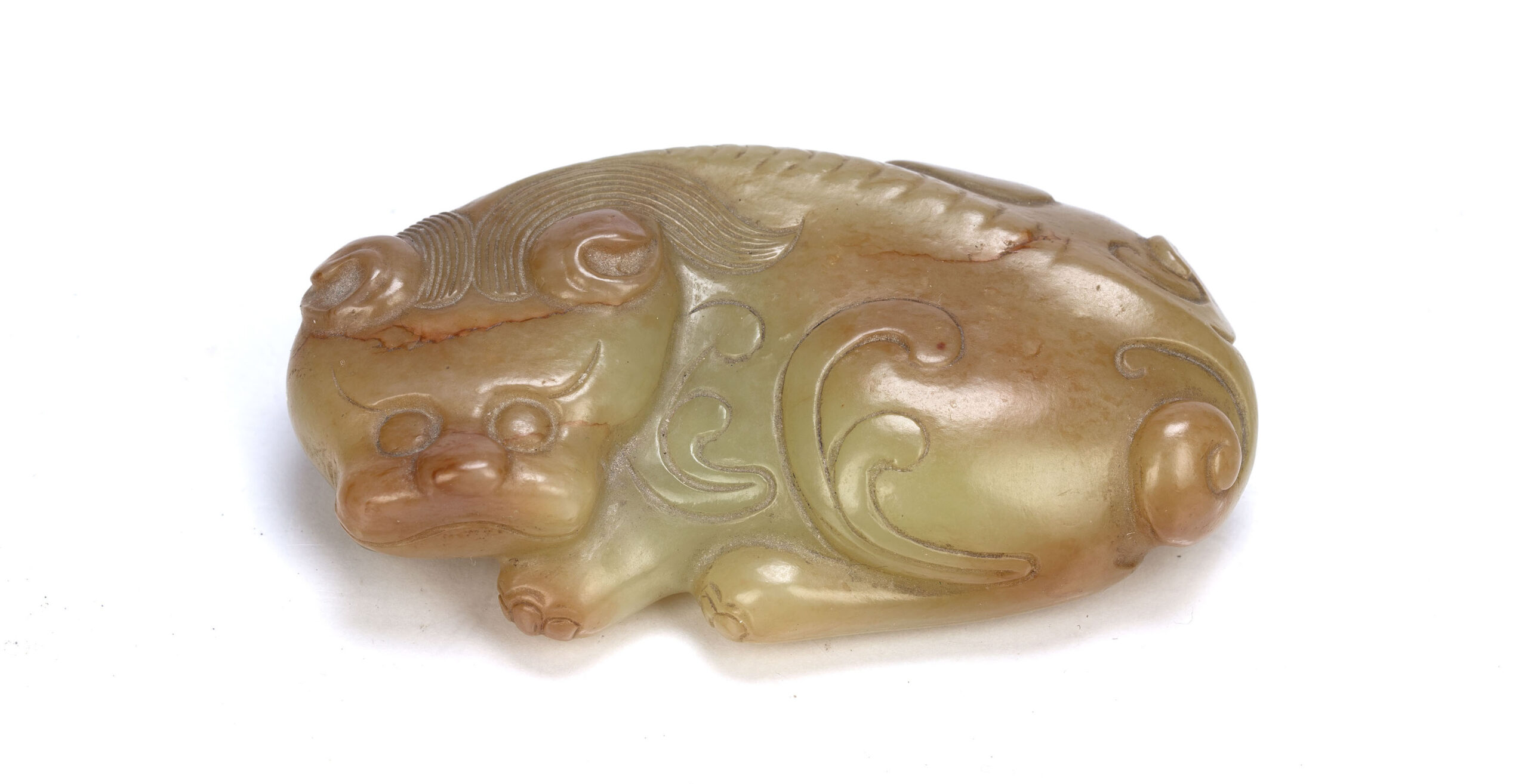 Tang style greyish green and russet marked jade pebble