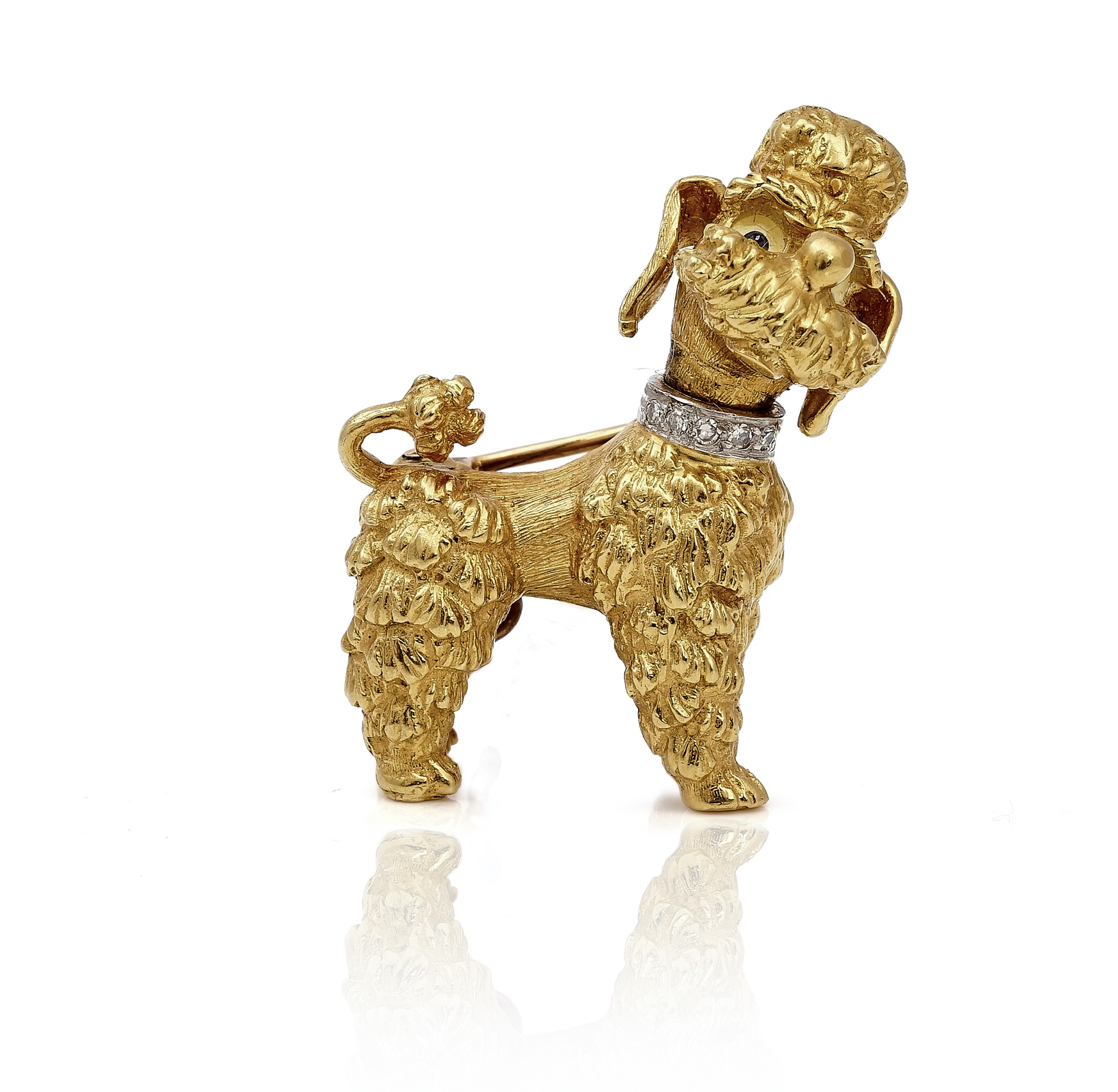 A gold poodle brooch