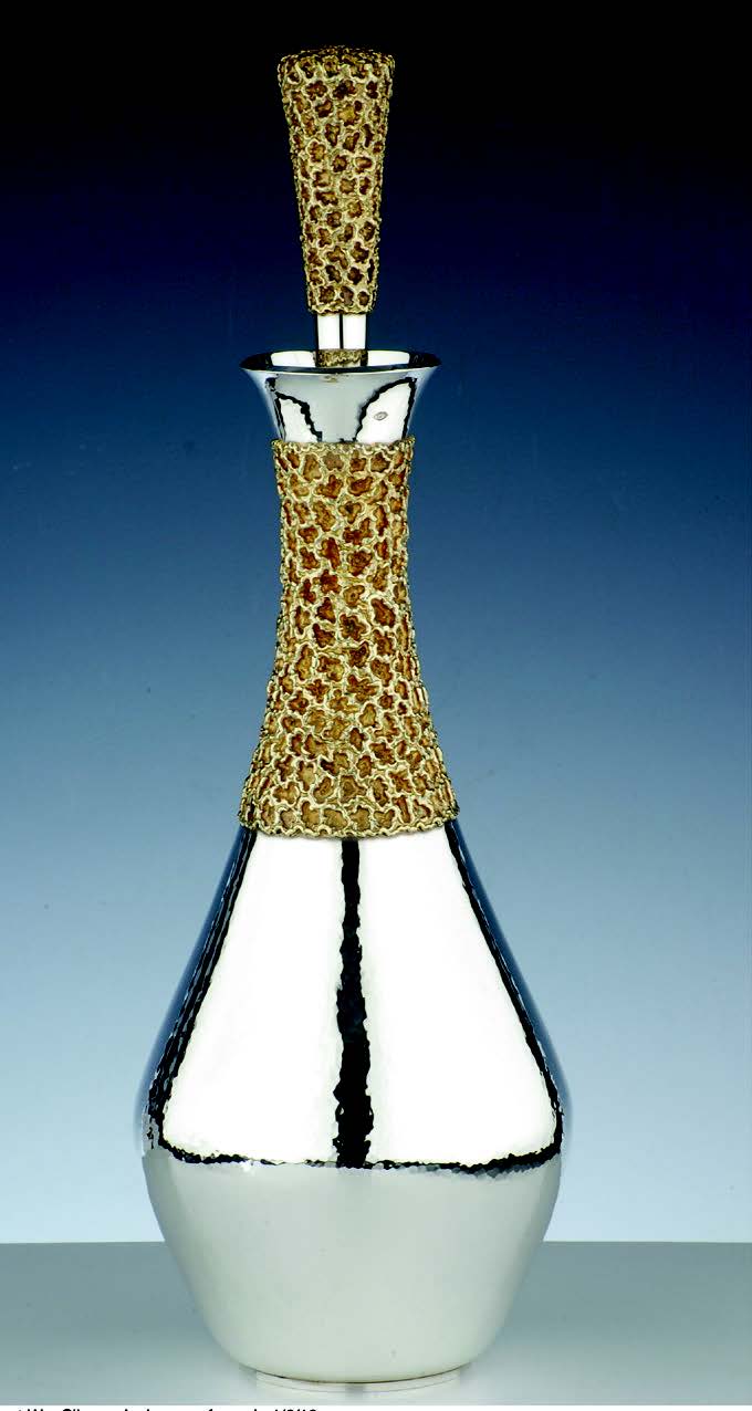 Stuart Devlin (1931-2018), a hand raised decanter with its neck and stopper encased in a silver gilt honeycomb embellishment