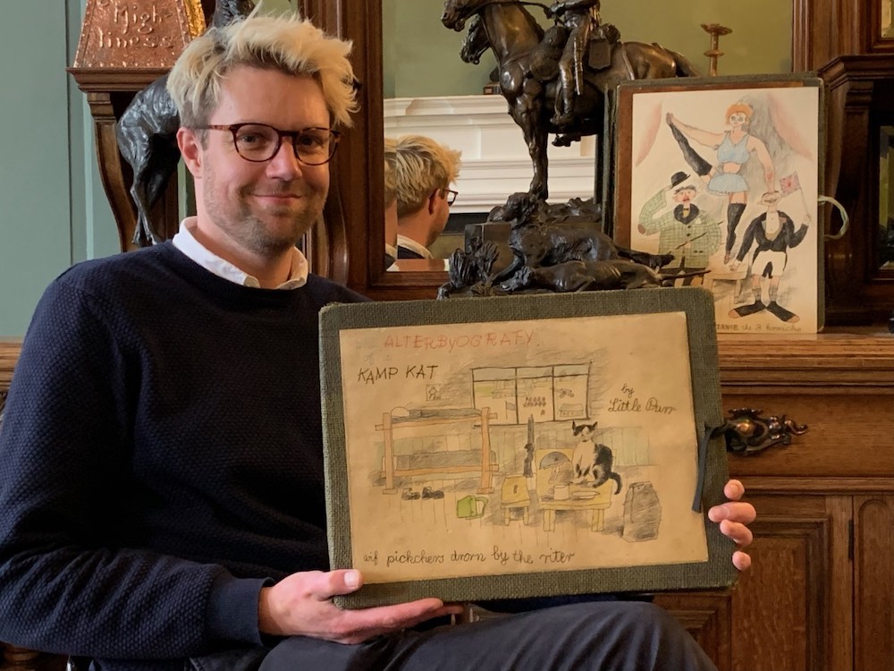 Hansons valuer Jim Spencer with a collection of WWII cartoon artworks