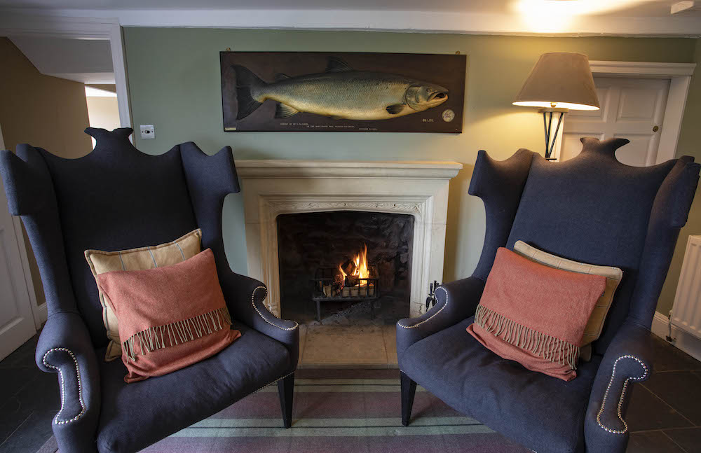 The carved wooden salmon hanging on the wall of the boathouse