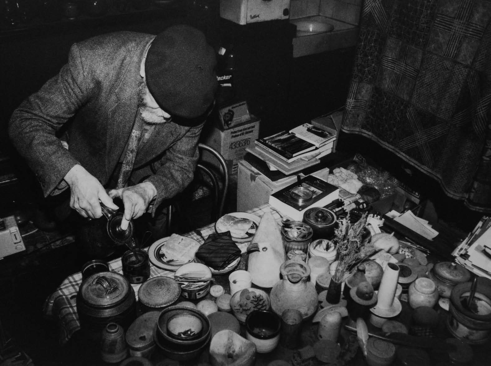 W.A. Ismay pouring coffee in his kitchen