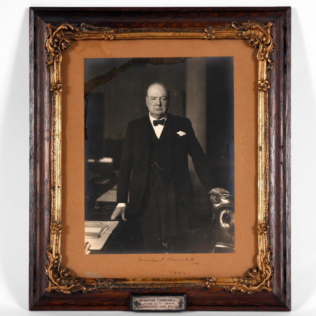 A wartime photograph of Winston Churchill standing by his dsek