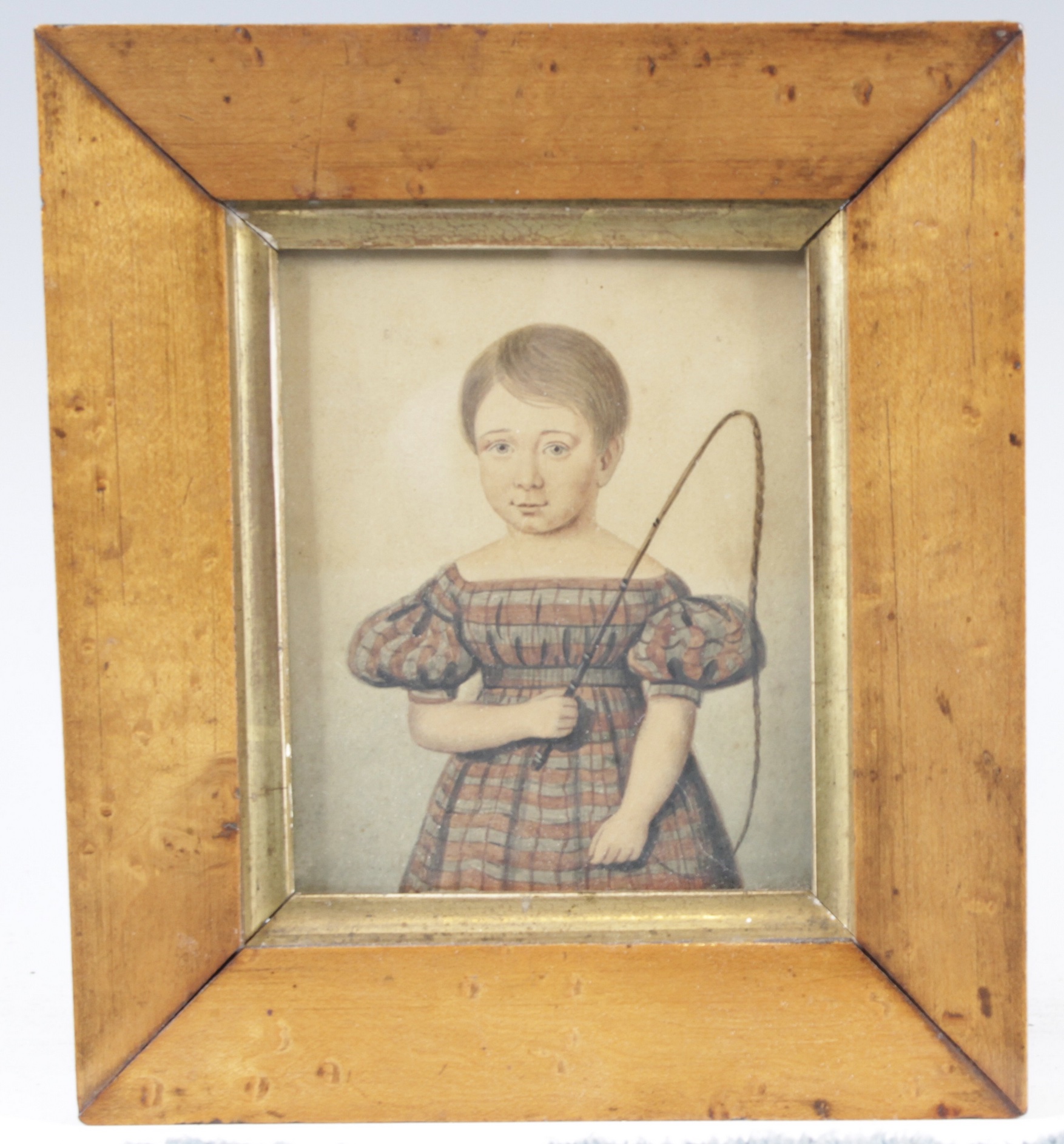 Half-length portrait of a young girl with riding crop, miniature watercolour on paper, circa 1830 