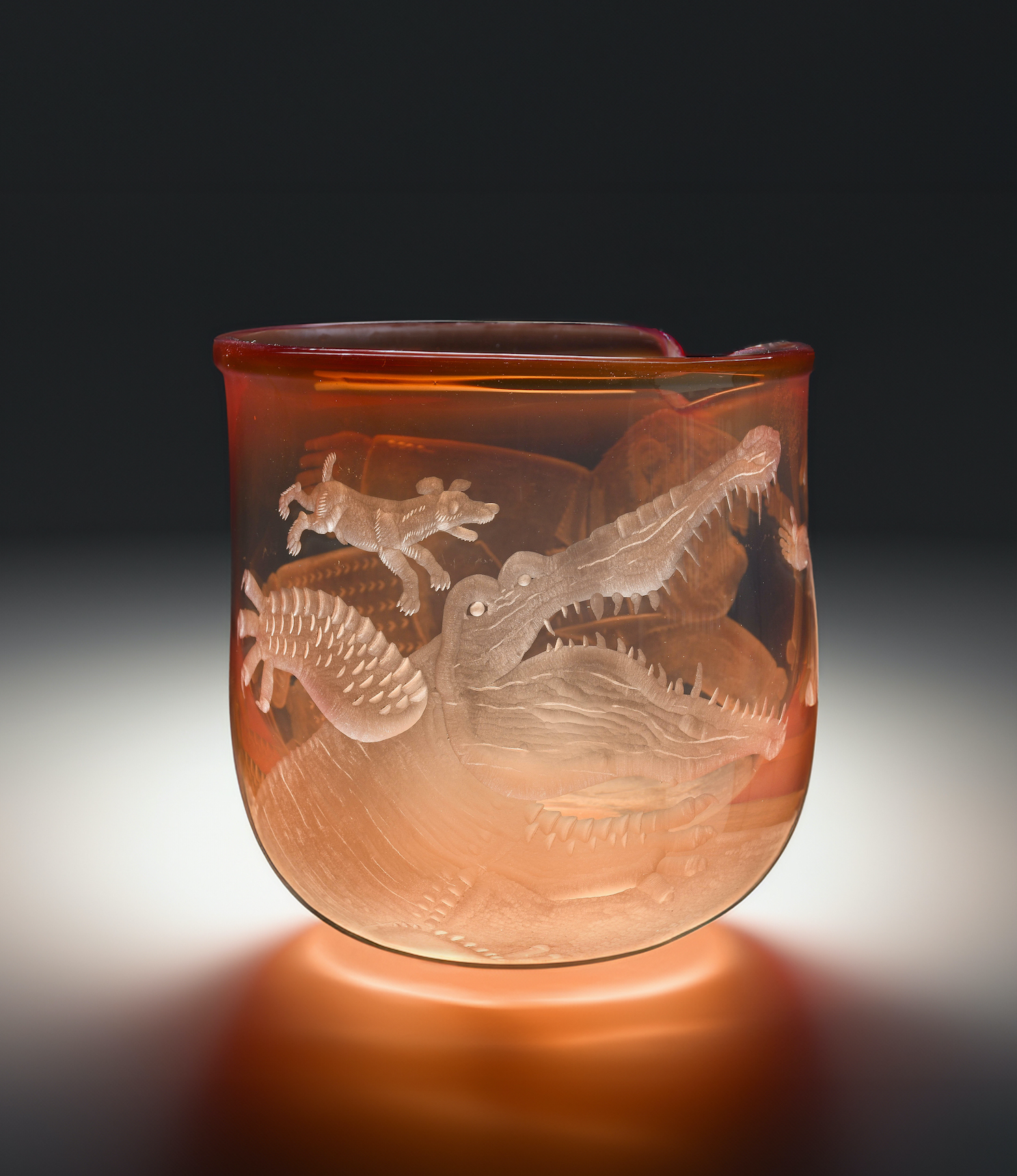 A wheel-engraved amber glass by Ronald Pennell