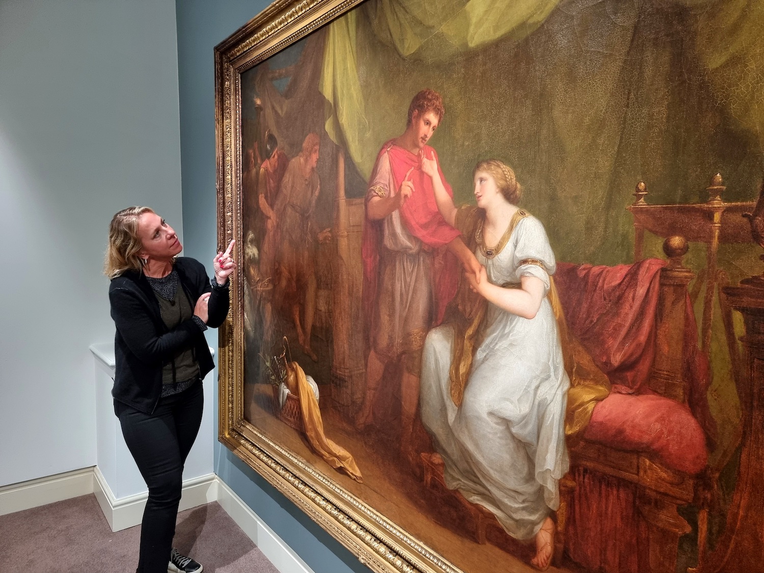 Conservator Sophie Reddington with conserved Diomedes and Cressida painting at Petworth
