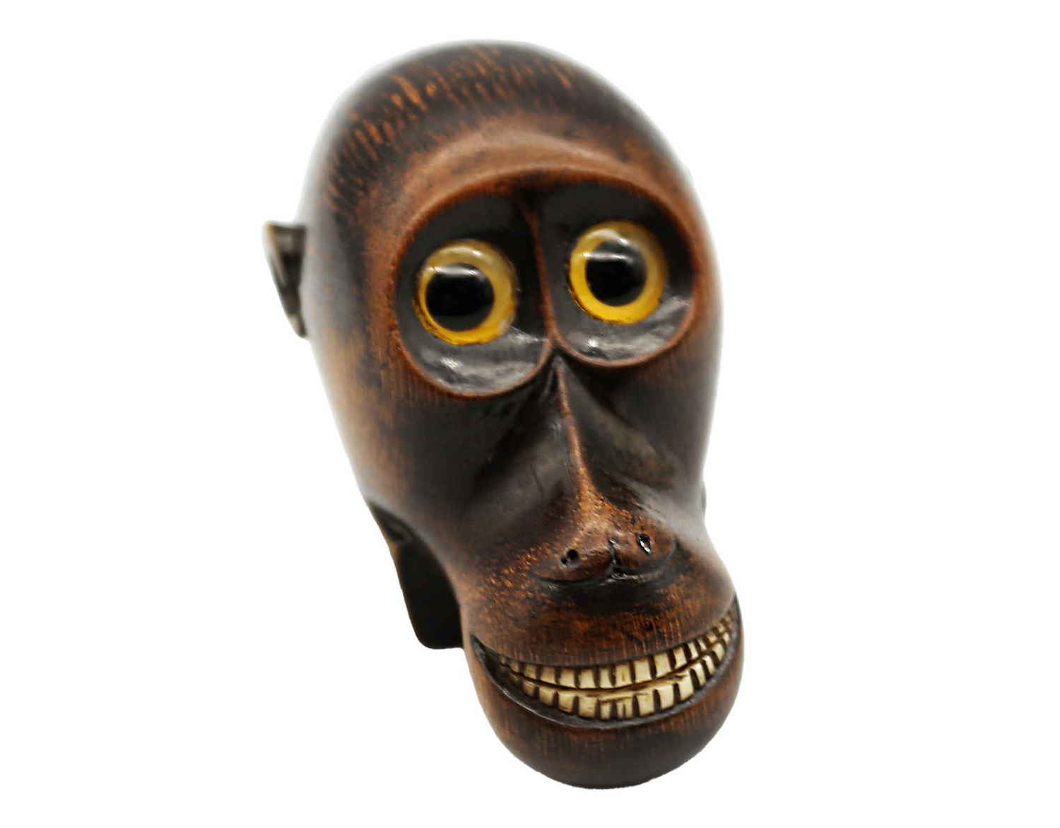 An early 19th century carved ebonised sycamore snuff box in the form of an exaggerated monkey head