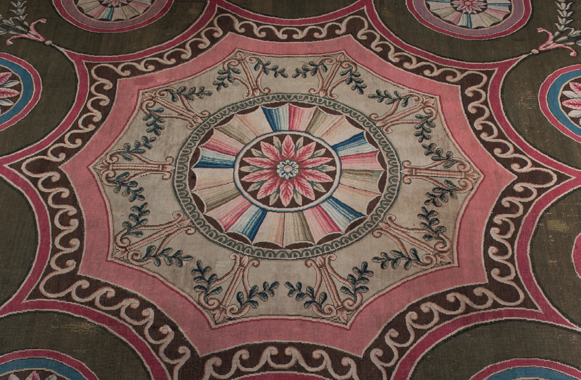 The original Axminster carpet, using bold pink and green, in the Music Room at Harewood House