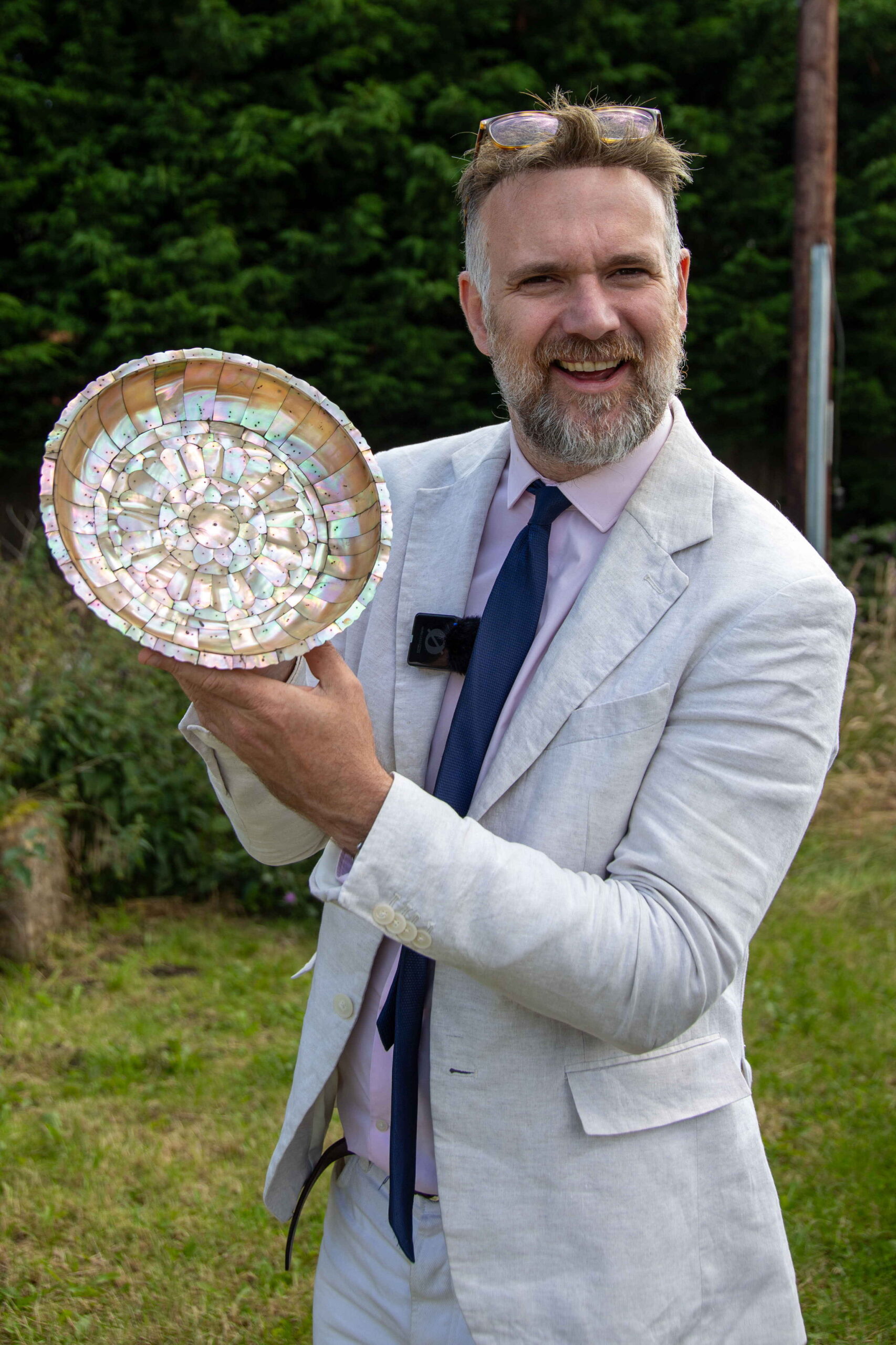 Charles Hanson with a late 16th or early 17th century mother-of-pearl, Indo-Portuguese dish