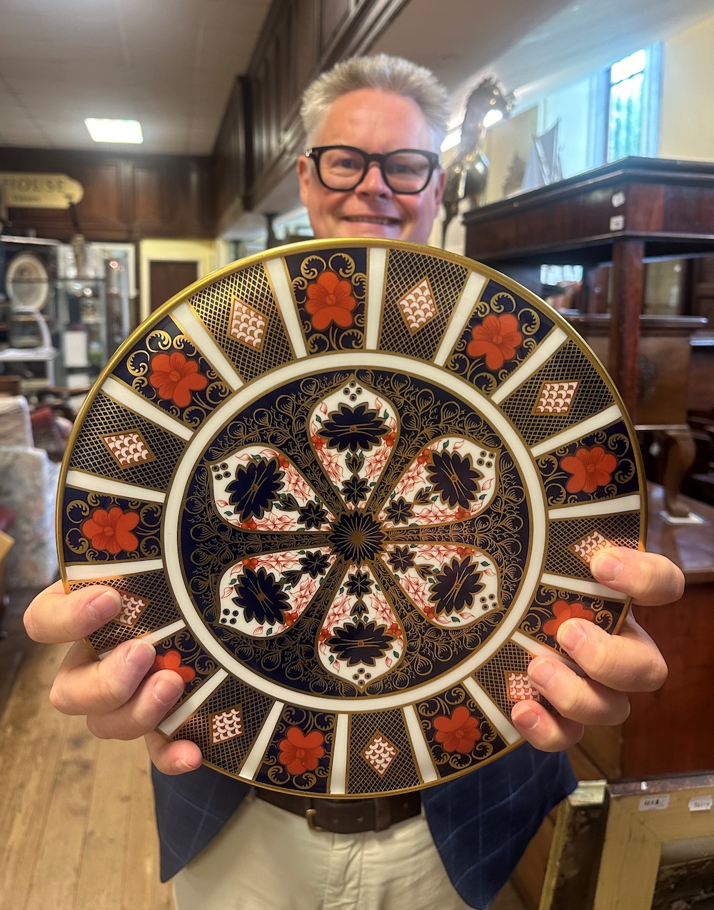 Auctioneer Richard Bromell and a Royal Crown Derby plate