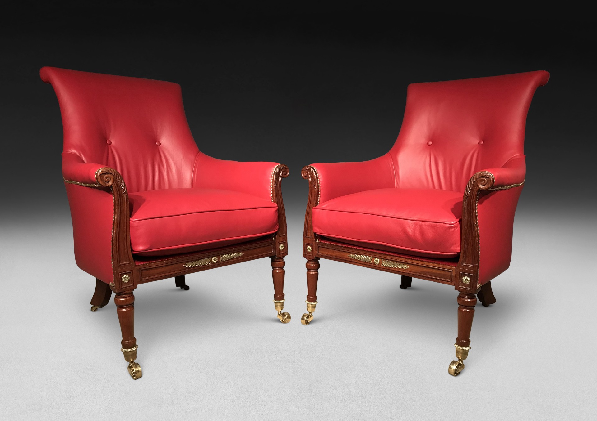 A pair of antique Gillows library armchairs