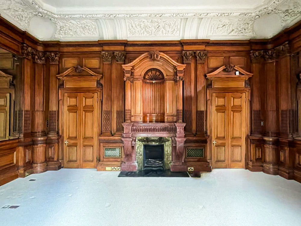 A fireplace and matching panelled room by George Trollope and Sons