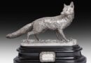 A life-size silver sculpture of a fox