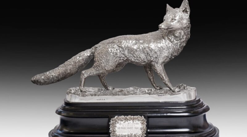 A life-size silver sculpture of a fox