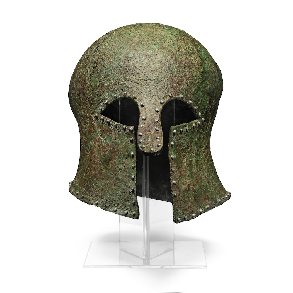 A Greek bronze Corinthian helmet with silver rivets, circa 7th–6th Century BC