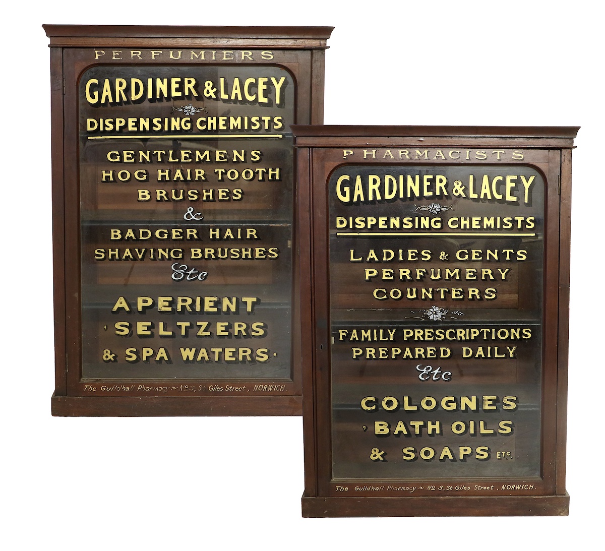 A pair of antique pharmacy cabinets with gold painted lettering 