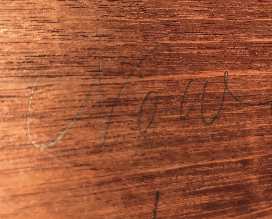 A maker's signature on an antique desk