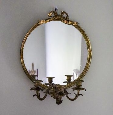 A 1950s round gilt framed girandole mirror from Janey Cave Antiques