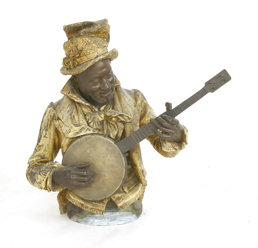 A cold painted spelter figure of a black musician